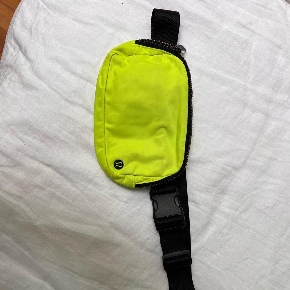 Neon green lululemon belt bag with black strap